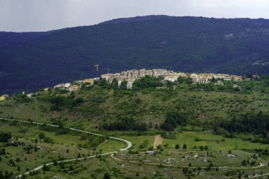Mountain landscape at Gran Sasso Natural Park, in Abruzzo, Italy, L Aquila province, at springtime (June). View of Castelvecchio Calvisio, historic village