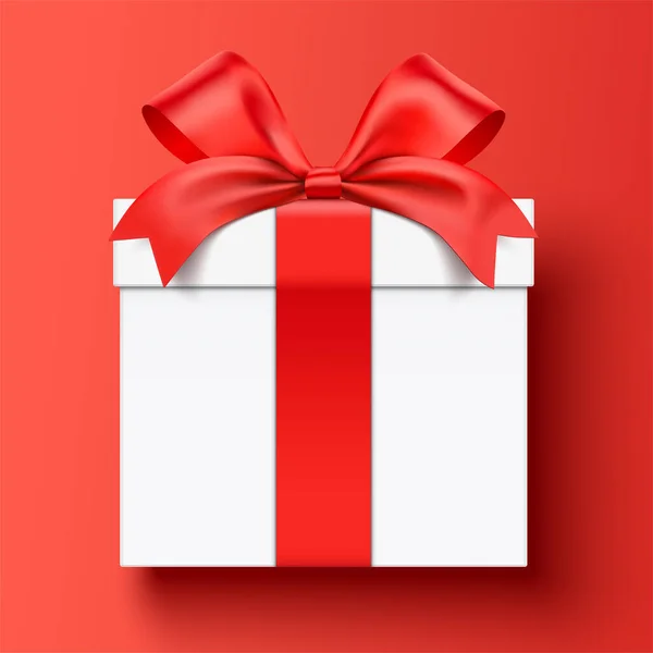 White gift box wrapped with red ribbon, lying down on a red background. — Stock Vector