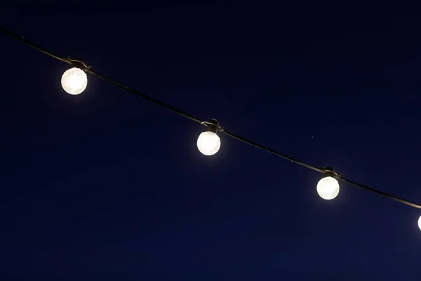 Garlands of light bulbs in the dark — Stok fotoğraf