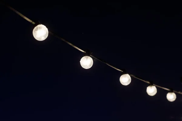 Garlands of light bulbs in the dark — Stok fotoğraf