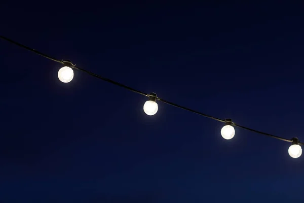 Garlands of light bulbs in the dark — Stok fotoğraf