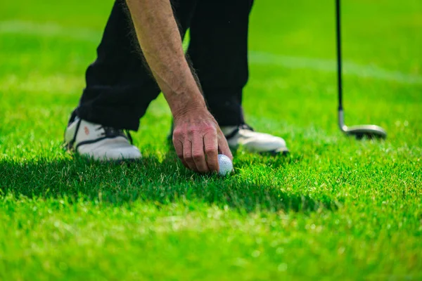 Playing golf. Golf course. Golf ball.