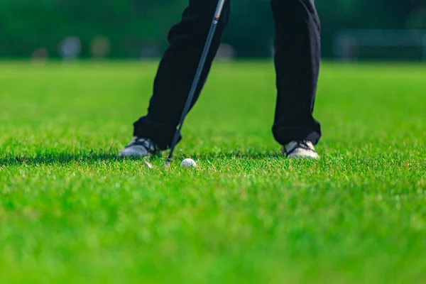 Playing golf. Golf course. Golf ball.