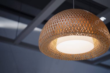 Woven bamboo lamp with black gray steel frame background