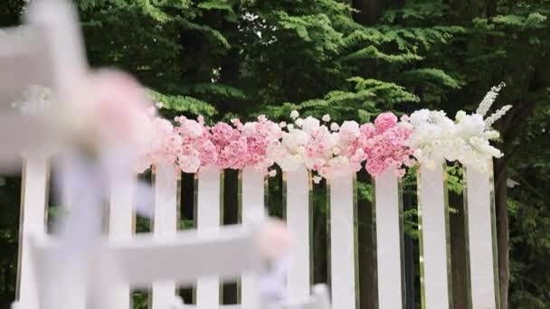 Arco nuziale con fiori freschi il giorno del matrimonio soleggiato estivo. Decorazioni di nozze con fiori. Bellissimo arredamento da sposa — Video Stock
