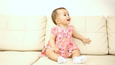 kanepede oturan gülen bebek