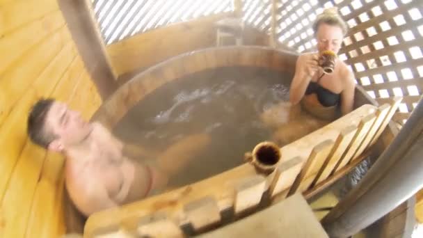 Couple sitting in hot water outdoor at winter — Stock Video