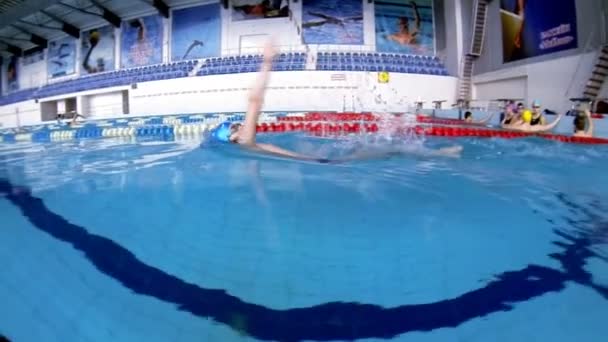 Beautiful underwater view of swimming backstorke style — Stock Video