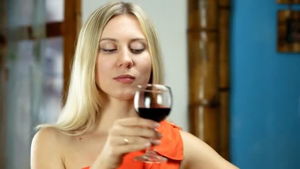 Bella donna bionda beve vino rosso al bar — Video Stock