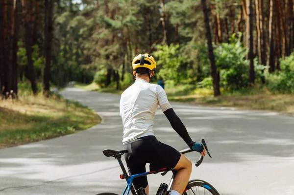 Professional Cyclist Trains Woods Fresh Air Stands Asphalt Road Beautiful — Stock Photo, Image