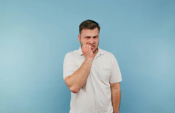 Hombre Nervioso Con Una Camiseta Blanca Aislada Sobre Fondo Azul — Foto de Stock