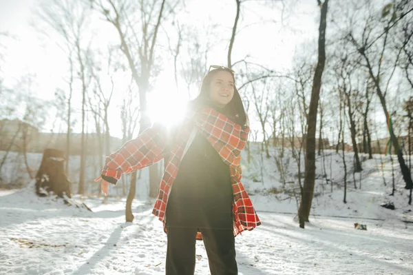 Positive Woman Shirt Stands Winter Forest Smiles Poses Camera Sun — Zdjęcie stockowe