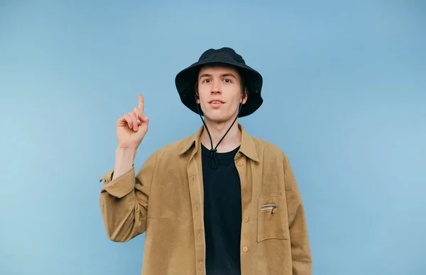 Positive Hipster Shirt Panama Stands Blue Background Points His Finger — Fotografia de Stock