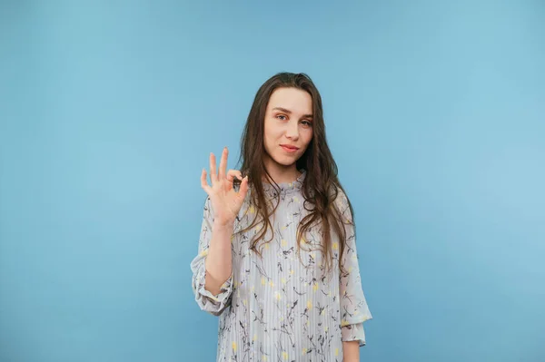 Cute Brunette Lady Dress Stands Blue Background Shows Gesture Smile — Fotografia de Stock