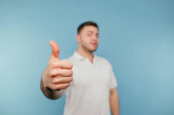 Man White Shirt Shows Gesture Thumbs Blue Background — стоковое фото