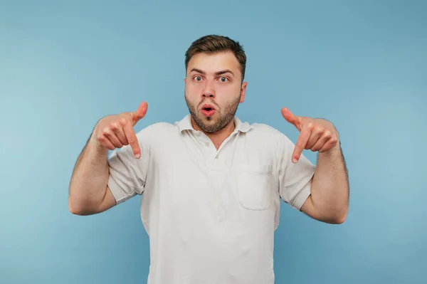 Surprised Man Bristles White Shirt Stands Blue Background Shows His — стоковое фото