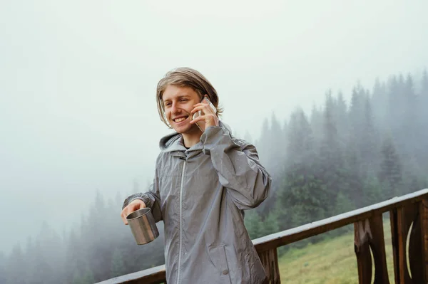 Happy Young Male Tourist Jacket Stands Terrace Mountains Cup Tea — Foto de Stock