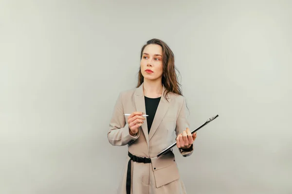 Attractive Woman Suit Tablet Pen Her Hands Stands Beige Background — Stok fotoğraf
