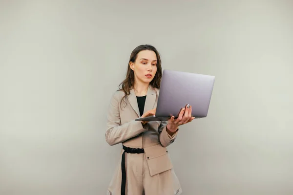 Beautiful Woman Jacket Laptop Hands Stands Beige Background Works — Stockfoto