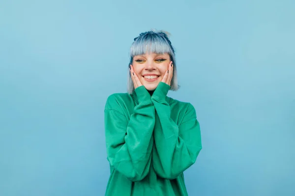 Joyful Girl Blue Hair Stands Green Background Smile His Face — стоковое фото