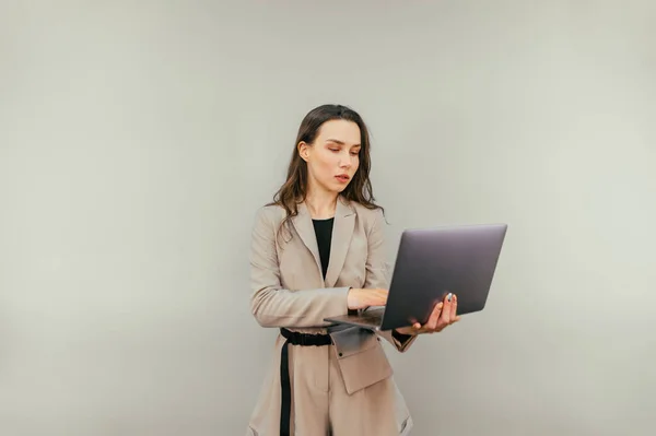 Business Woman Beige Suit Opens Laptop Work Serious Face Beige — Stockfoto
