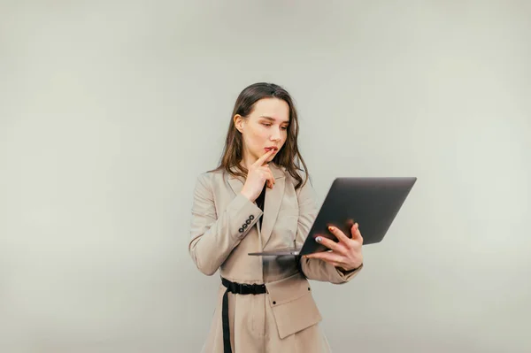 Portrait Pensive Business Woman Beige Suit Laptop His Hands Stands — Stockfoto