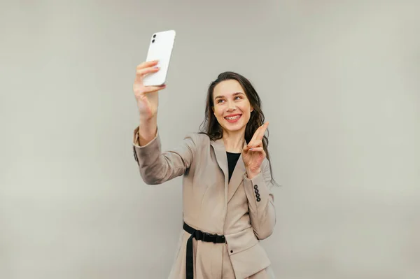 Joyful Lady Jacket Stands Beige Background Smile Her Face Takes — стоковое фото