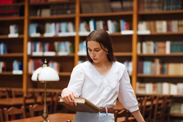 Attractive Woman Standing Book Hand Public Library Reads Serious Face — Stockfoto