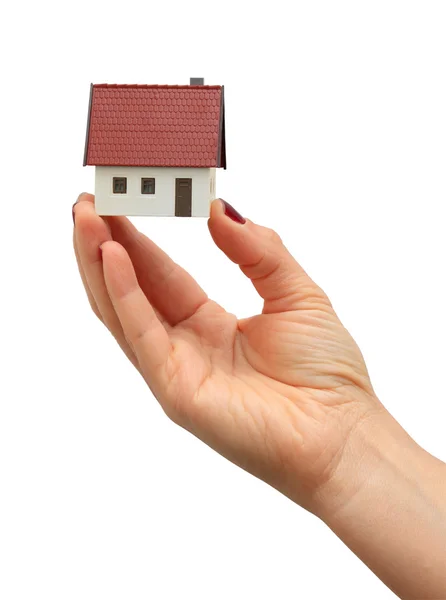 Mão segurando uma nova casa isolada sobre fundo branco — Fotografia de Stock