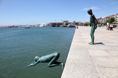Los Raqueros sculpture at the promenade of Santander, Cantabria, Spain clipart