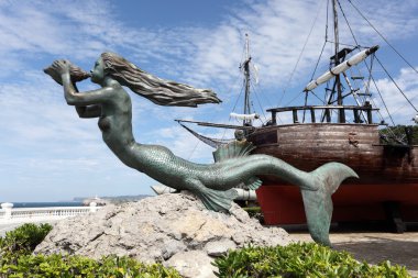 Mermaid sculpture at historic sailing ship in Santander, Cantabria, Spain clipart