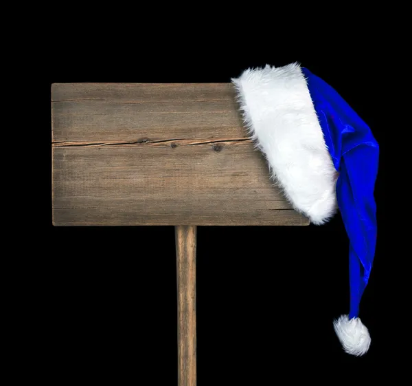 Wooden road sign with Santa hat isolated on black background — Stock Photo, Image