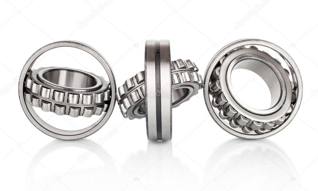 Composition of steel ball roller bearings in closeup isolated on white background