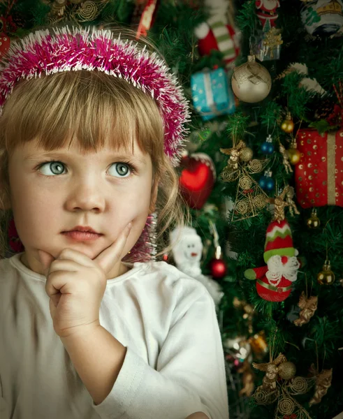 Little child girl near Christmas tree. Happy new year Stock Image