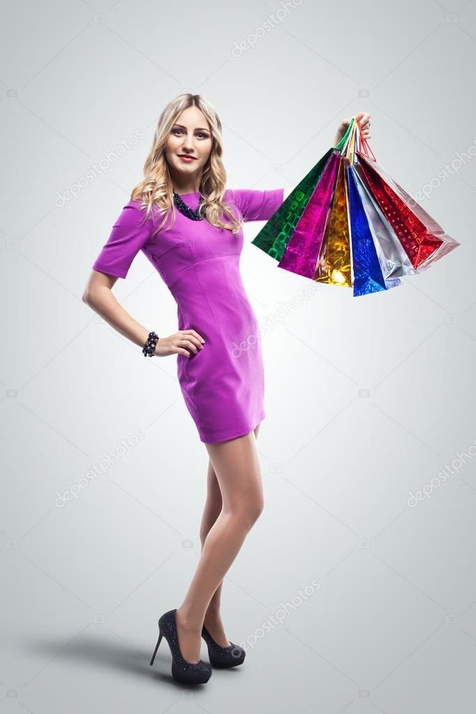 Fashion Sexy Girl in dress, full length Portrait. Woman with Shopping Bags.