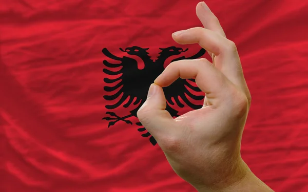 Ok gesto frente a la bandera nacional de Albania —  Fotos de Stock