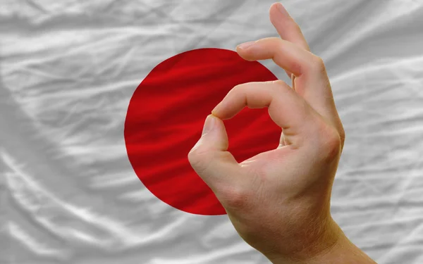 Ok gesto frente a la bandera nacional de Japón —  Fotos de Stock