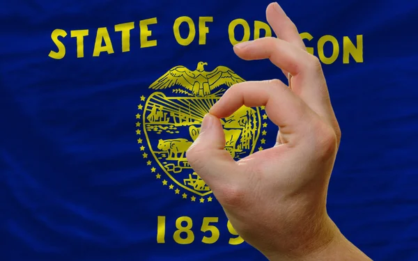 Ok gesture in front of oregon us state flag — Stock Photo, Image