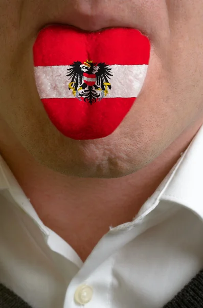 Man tongue painted in austria flag symbolizing to knowledge to s — Stock Photo, Image