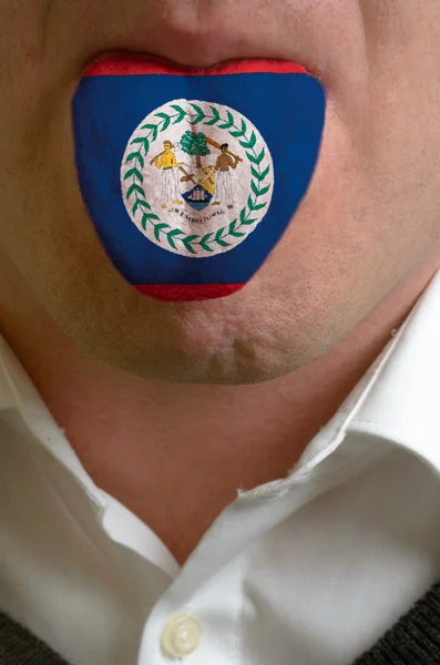 Man tongue painted in belize flag symbolizing to knowledge to sp — Stock Photo, Image