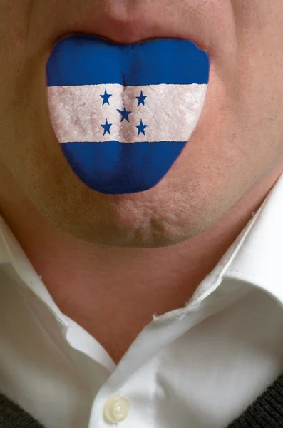 Man tongue painted in honduras flag symbolizing to knowledge to — Stock Photo, Image