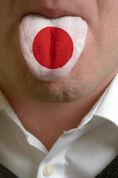 Língua homem pintado no japão bandeira simbolizando ao conhecimento de spe — Fotografia de Stock