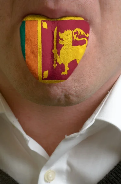 Mannen tungan målade i sri Lankas flagga symboliserar kunskap till — Stockfoto