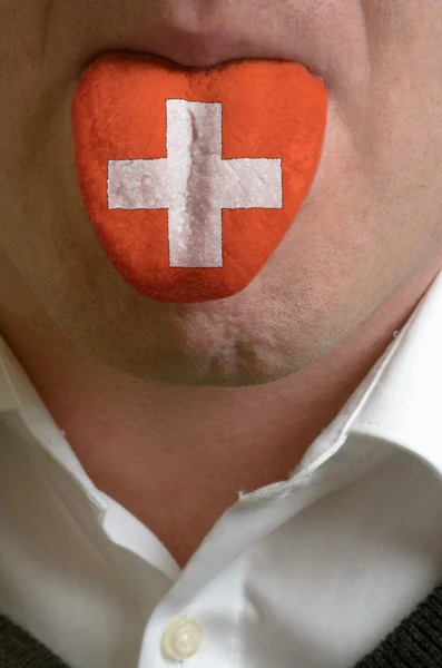 Lengua humana pintada en la bandera de Suiza que simboliza el conocimiento — Foto de Stock