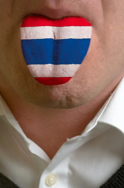 Man tongue painted in thailand flag symbolizing to knowledge to — Stock Photo, Image