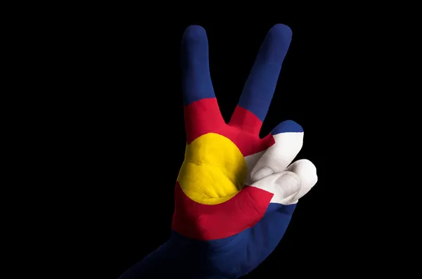 Colorado us state flag two finger up gesture for victory and win — Stock Photo, Image