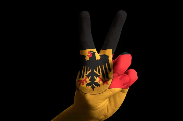 Germany national flag two finger up gesture for victory and winn — Stock Photo, Image