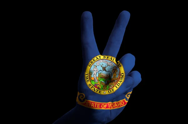 Idaho us state flag two finger up gesture for victory and winner — Stock Photo, Image