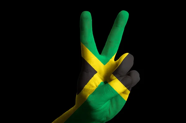 Jamaica national flag two finger up gesture for victory and winn — Stock Photo, Image