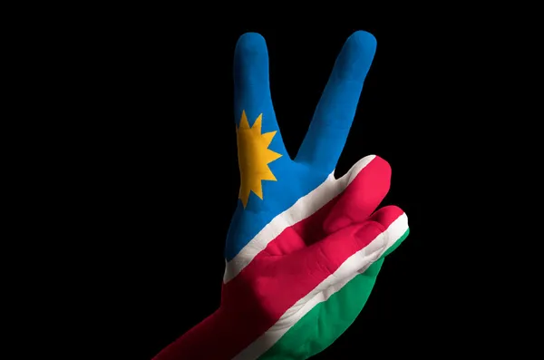 Namibië nationale vlag twee vinger omhoog gebaar voor overwinning en winn — Stockfoto